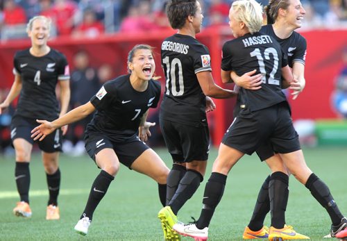 New Zealand's #7  #A7 Ali Riley reacts as she waits to congratulate #6 Rebekah Stott (Right) who opened the scoring against team China in FIFA action at Investor's FIeld in WInnipeg Monday. June 15, 2015 - (Phil Hossack / Winnipeg Free Press)