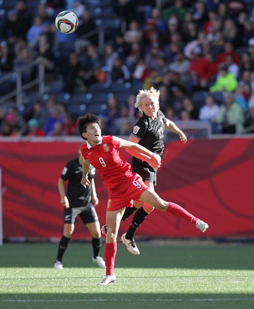 New Zealand's #12 Betsy Hassett and CHina's # 9 Shanshan Wang look for the header rebound in FIFA action at Investor's FIeld in WInnipeg Monday. June 15, 2015 - (Phil Hossack / Winnipeg Free Press)