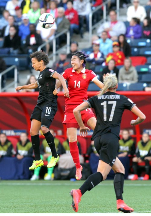 New Zealand's #10 Sara Gregorious and CHina's #14 Rong Zhao  head the ball in FIFA action at Investor's FIeld in WInnipeg Monday. June 15, 2015 - (Phil Hossack / Winnipeg Free Press)