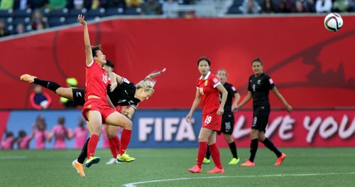 China's #16 Jiahui Lou and New Zealand's #4 Katie Duncan collide mid air after heading the ball Monday at the Investor's Group Stadium in FIFA action. See story. June 15, 2015 - (Phil Hossack / Winnipeg Free Press)