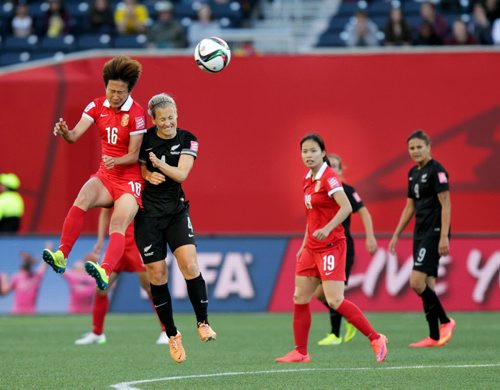 China's #16 Jiahui Lou and New Zealand's #4 Katie Duncan collide mid air heading the ball Monday at the Investor's Group Stadium in FIFA action. See story. June 15, 2015 - (Phil Hossack / Winnipeg Free Press)