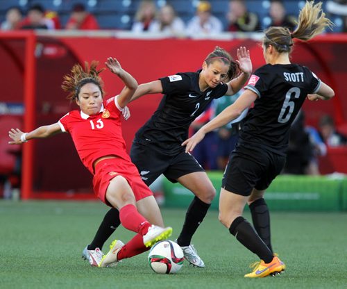 China's #13 Jiali Tang  battles for control against New Zealand's #2 Ria Percival and #6 Rebekah Stott Monday at Investor's FIeld in FIFA action. See Story. June 15, 2015 - (Phil Hossack / Winnipeg Free Press)