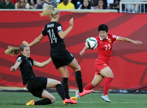 China's #23Guixin Ren retrieves a pass in front of New Zealand's #14  Katie Bowen and #6 Rebekah Stott Monday at Investor's FIeld in FIFA action. See Story. June 15, 2015 - (Phil Hossack / Winnipeg Free Press)