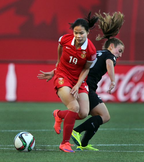 China's #19 Ruyin Tan keeps New Zealand's #16 Annalie Longo at bay Monday at Investor's FIeld in FIFA action. See Story. June 15, 2015 - (Phil Hossack / Winnipeg Free Press)