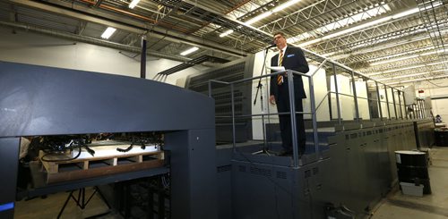 Curwin Friesen, CEO at Friesens Corporation in Altona,Mb.  at the podium on their new MAN Roland press speaks to a pressroom full of employees and business leaders Tuesday.    Martin Cash story Wayne Glowacki / Winnipeg Free Press June 16  2015