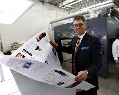 Curwin Friesen, CEO at Friesens Corporation in Altona,Mb. with a printed page from  their new MAN Roland press Tuesday.  Martin Cash story Wayne Glowacki / Winnipeg Free Press June 16  2015