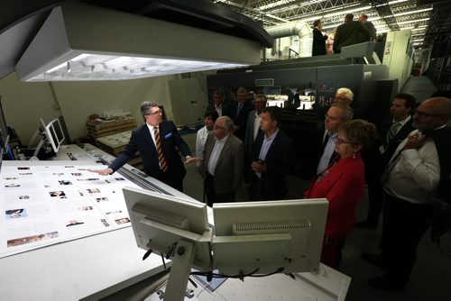 At left, Curwin Friesen, CEO at Friesens Corporation in Altona,Mb. gives a tour of the  operator's console for their new MAN Roland press after the ribbon cutting ceremony  Tuesday.  Martin Cash story Wayne Glowacki / Winnipeg Free Press June 16  2015