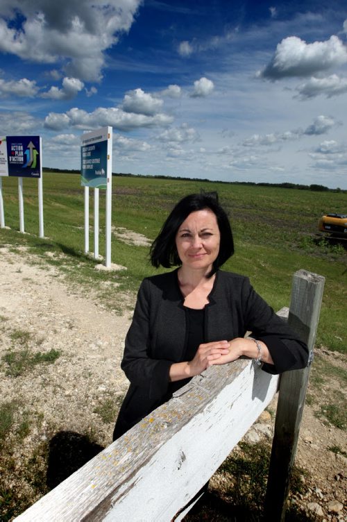 St. Adolphe is expanding its dike at a cost of $7 m to allow for urban sprawl. It has not been able to grow like Ste. Agathe because of the tighter dike, even though it's closer to Wpg. RM of Ritchot Mayor Jackie Hunt poses for a photo on the old dike with the area that will have expansion in the back. BORIS MINKEVICH/WINNIPEG FREE PRESS June 16, 2015