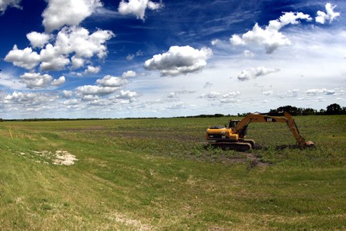 St. Adolphe is expanding its dike at a cost of $7 m to allow for urban sprawl. It has not been able to grow like Ste. Agathe because of the tighter dike, even though it's closer to Wpg. Photo taken near the area that will have the expansion. BORIS MINKEVICH/WINNIPEG FREE PRESS June 16, 2015