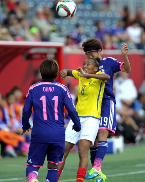 Equador's # 8 Erika Vasquez checks the incoming ball while colliding with Japan's #19 Saori Ariyoshi. #11 Shinobu Ohno looks on. June 16, 2015 - (Phil Hossack / Winnipeg Free Press)