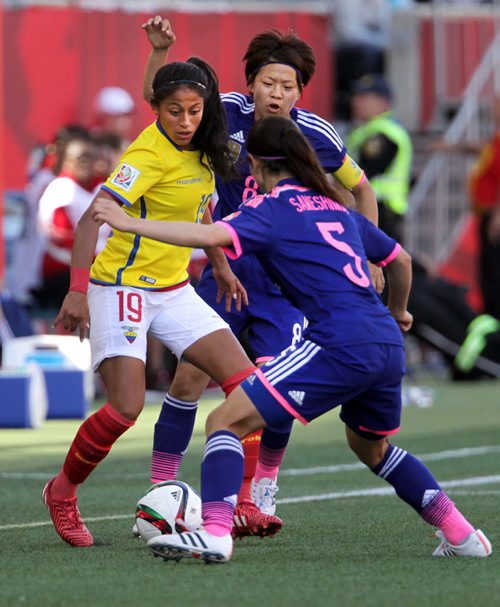 Equador's #19Kerlly Real tangles for possession Tuesday with Japan's #5 Aya Samashima and #8 Aya Miyama. Japan prevailed 1-0 in the final Winnipeg FIFA match.. See story.June 16, 2015 - (Phil Hossack / Winnipeg Free Press)