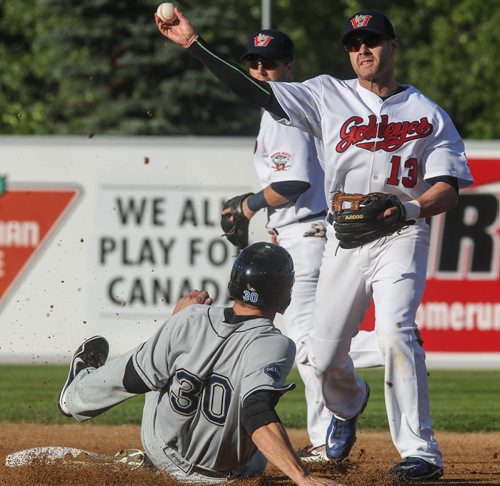Goldeyes' Josh Mazzola (13) goes for a double play after base tagging St. Paul Saints' Ian Gac (30) during the second inning of Winnipeg Goldeyes action against the St. Paul Saints at Shaw Park Tuesday evening. 150616 - Tuesday, June 16, 2015 -  MIKE DEAL / WINNIPEG FREE PRESS
