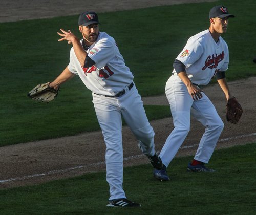 Goldeyes' starting pitcher Nick Hernandez (41) tries to throw to first base after an infield bunt while Kyle Brandenburg (17) moved in for backup during Winnipeg Goldeyes action against the St. Paul Saints at Shaw Park Tuesday evening. 150616 - Tuesday, June 16, 2015 -  MIKE DEAL / WINNIPEG FREE PRESS