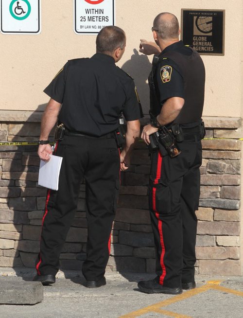 Police have tapped off a large area around Legends Bar & Grill near the Courts of St James apartments at Portage Ave and Woodhaven Blvd after reports of shots fired at 5 AM in the area - Breaking News- June 17, 2015   (JOE BRYKSA / WINNIPEG FREE PRESS)