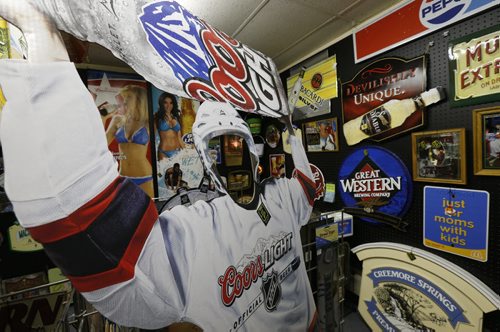 Sunday, This City.  The location is The Rec Room, 377 Henderson Hwy (lower level),  the owners are Glenn and Vera Maskiw. Cardboard cut out and beer signage..  Dave Sanderson story.   Wayne Glowacki / Winnipeg Free Press June 17  2015