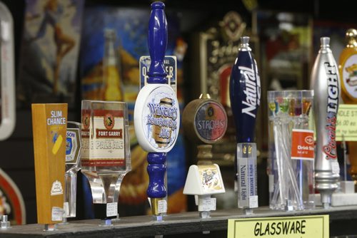 Sunday, This City.  The location is The Rec Room, 377 Henderson Hwy (lower level),  the owners are Glenn and Vera Maskiw. Some of the beer tap handles on display.. Dave Sanderson story.   Wayne Glowacki / Winnipeg Free Press June 17  2015
