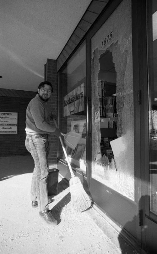 (Archival photo) James Beauchamp, a worker at McNally-Robinson, sweeps up shattered glass after the store was vandalized for stocking Salman Rushdie's The Satanic Verses. Feb. 22, 1989. Jeff De Booy / Winnipeg Free Press