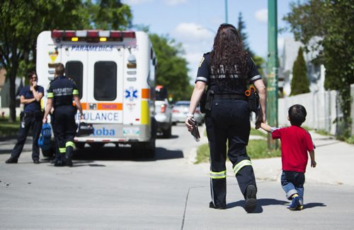 Children are evacuated from a fire at a day home at 703 Burrows Avenue in Winnipeg on Thursday, June 18, 2015.  Nobody appeared to be injured. Mikaela MacKenzie / Winnipeg Free Press