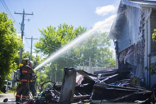 A garage fire at 703 Burrows Avenue in Winnipeg on Thursday, June 18, 2015.  Nobody appeared to be injured, but children in a day home were evacuated. Mikaela MacKenzie / Winnipeg Free Press