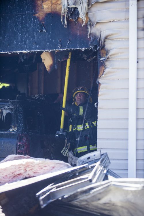 A garage fire at 703 Burrows Avenue in Winnipeg on Thursday, June 18, 2015.  Nobody appeared to be injured, but children in a day home were evacuated. Mikaela MacKenzie / Winnipeg Free Press