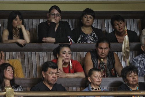 Marlene Orgeron (back row second from right), adoptee, '60s Scoop survivor listens to Premier Greg Selinger offers an apology from the people of Manitoba during question period in the Manitoba Legislative Building Thursday.  150618 June 18, 2015 MIKE DEAL / WINNIPEG FREE PRESS