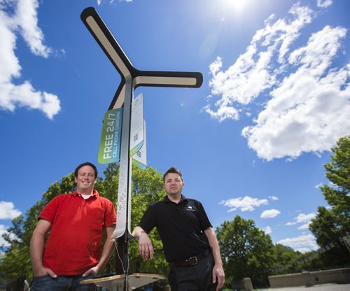 Alex Stuart (left) and Justin Phillips, co-founders of Sycamore Inc, stand in front of one of their mobile solar cell phone charging station installation in Winnipeg on Thursday, June 18, 2015.  This station at the Forks is the first of its kind in Canada. Mikaela MacKenzie / Winnipeg Free Press