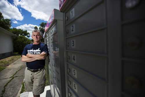 Wayne Roseberry stands by the community mailbox beside his house that has created many hassles for him in Winnipeg on Thursday, June 18, 2015.  He does not appreciate the increased volume of people, as well as the fact that Canada Post does not properly maintain the area. Mikaela MacKenzie / Winnipeg Free Press