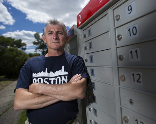 Wayne Roseberry stands by the community mailbox beside his house that has created many hassles for him in Winnipeg on Thursday, June 18, 2015.  He does not appreciate the increased volume of people, and the fact that Canada Post does not properly maintain the area. Mikaela MacKenzie / Winnipeg Free Press