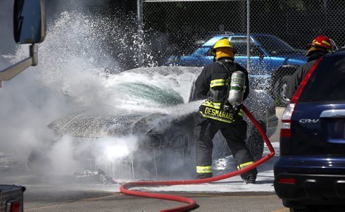 Winnipeg Fire Fighters arrived at the parking lot of the Superstore on McPhillips St. Thursday afternoon to extinguish a burning four door sedan. No one was injured but a vehicle parked nearby was also damaged. Wayne Glowacki / Winnipeg Free Press June 18  2015