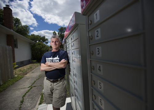 Wayne Roseberry stands by the community mailbox beside his house that has created many hassles for him in Winnipeg on Thursday, June 18, 2015.  He does not appreciate the increased volume of people, and the fact that Canada Post does not properly maintain the area. Mikaela MacKenzie / Winnipeg Free Press
