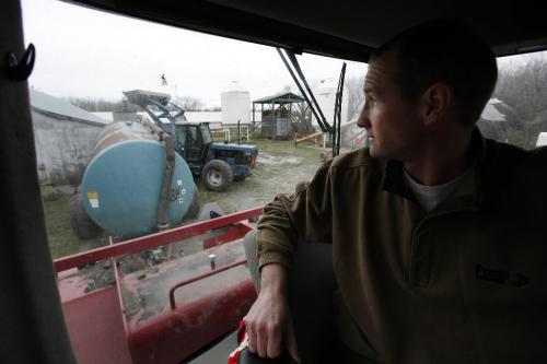 John Woods / Winnipeg Free Press / November 16/07- 071116  - Hog farmer Craig Riese watches from the tractor as his farm hand moves some machinery on his farm just north of Winnipeg Friday November 16/07.   Riese says with hog prices low and his expenses high due to the increase in grain feed prices it is hard to make a living.