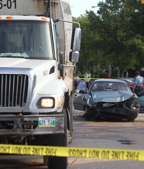 A serious mva between a garbage truck and a car at St Mathews Ave and Arlington St. has sent two people ( from car) to hospital in critical condition Friday morning-Police have intersection blocked in every direction as they investigate the scene   Breaking News- June 19, 2015   (JOE BRYKSA / WINNIPEG FREE PRESS)