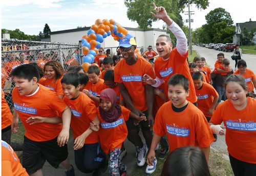 And their off.    Winnipeg Police Chief Devon Clunis, centre at left, beside Kevin Chief, MLA for Point Douglas with 130 students and teachers from Norquay School at the start of the Run With The Chiefs annual community fun run Friday. The event was sponsored by the North Point Douglas Seniors Association and Winnipeg Aboriginal Sport Achievement Centre to create and strengthen relationships that lead to a better, stronger and safer community.  Wayne Glowacki / Winnipeg Free Press June 19  2015