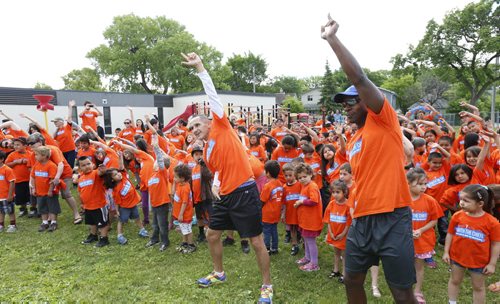 Winnipeg Police Chief Devon Clunis, at right and Kevin Chief, MLA for Point Douglas with 130 students and teachers from Norquay School warm up  prior to the Run With The Chiefs annual community fun run Friday. The event was sponsored by the North Point Douglas Seniors Association and Winnipeg Aboriginal Sport Achievement Centre to create and strengthen relationships that lead to a better, stronger and safer community.  Wayne Glowacki / Winnipeg Free Press June 19  2015