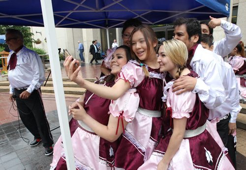 The Asham Stompers  take a selfie before they perform to a small crowd taking shelter from the rain at City Hall during National Aboriginal Day festivities Friday afternoon National Aboriginal Day recognizes and honours the cultures of First Nations, Metis and Inuit peoples. The Citys National Aboriginal Day celebration will began at 11:30 a.m. with a welcoming prayer and smudge , followed by statements from dignitaries and entertainment. - Standup Photo- June 19, 2015   (JOE BRYKSA / WINNIPEG FREE PRESS)