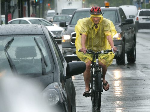 A cyclist on Osborne St. was ready for the light rain showers Friday afternoon. Wayne Glowacki / Winnipeg Free Press June 19  2015