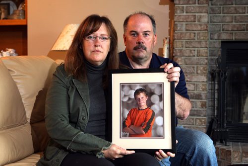 Corrine and Rob Read's son Nicholas is missing. Photo taken at their West St. Paul home of them holding most recent photos of Nicolas. BORIS MINKEVICH/WINNIPEG FREE PRESS June 19, 2015