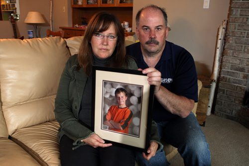 Corrine and Rob Read's son Nicholas is missing. Photo taken at their West St. Paul home of them holding most recent photos of Nicolas. BORIS MINKEVICH/WINNIPEG FREE PRESS June 19, 2015