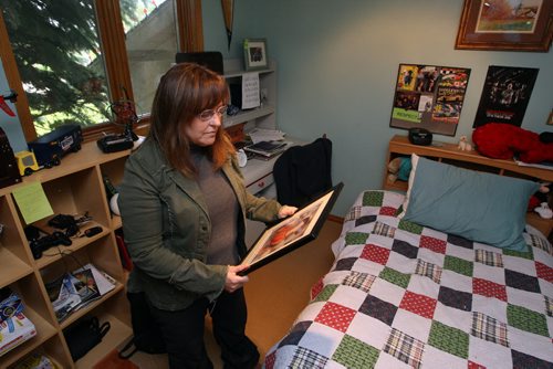 Corrine Read's son Nicholas is missing. Photo taken at their West St. Paul home.  She reflects in his bedroom. BORIS MINKEVICH/WINNIPEG FREE PRESS June 19, 2015