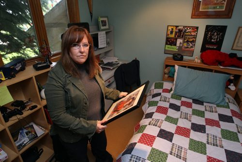 Corrine Read's son Nicholas is missing. Photo taken at their West St. Paul home.  She reflects in his bedroom. BORIS MINKEVICH/WINNIPEG FREE PRESS June 19, 2015