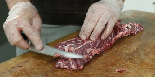 Butcher Dallas Black trims a Hanger steak at DeLuca's on Portage Ave.  Bart Kives  story.  Wayne Glowacki / Winnipeg Free Press June 19  2015