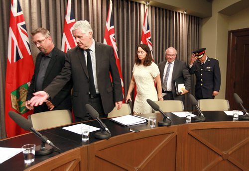 Attorney General Gord Mackintosh shows Robert Taman to his seat at a press conference Friday, followed by Nahanni Fontaine, Zane Tessler and Ian Grant. See story re: Independent Investigation Unit of Manitoba to take over investigations of serious incidents involving police officers June 19, 2015 - (Phil Hossack / Winnipeg Free Press)