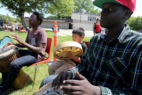 Matthew Ndaya, Alvin Deegan Jr. and Jeremie Kalimba all playing together at the Bread and Bannock Festival near the Community Oven at Norquay Community Centre, Saturday, June 20, 2015. An organizer said the focus of the event was about connecting First Nations people with new immigrants in the area. (TREVOR HAGAN/WINNIPEG FREE PRESS)