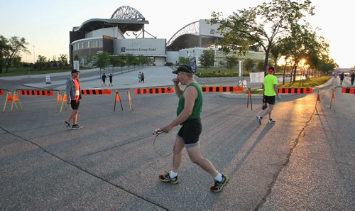 Participants arrive for the Manitoba Marathon early Sunday morning outside the IGF Stadium.  150621 June 21, 2015 MIKE DEAL / WINNIPEG FREE PRESS