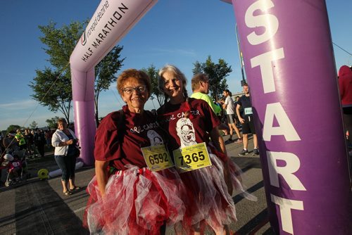 Participants Donna Butcher (left) and Susan Lash get ready for the Manitoba Half Marathon outside the IGF Stadium on Chancellor Matheson Road Sunday morning. Donna is from Winnipeg and at 61-years-old has survived two bouts of oral cancer, her friend Susan is from Illinois and came to run with her. 150621 - Sunday, June 21, 2015 -  MIKE DEAL / WINNIPEG FREE PRESS