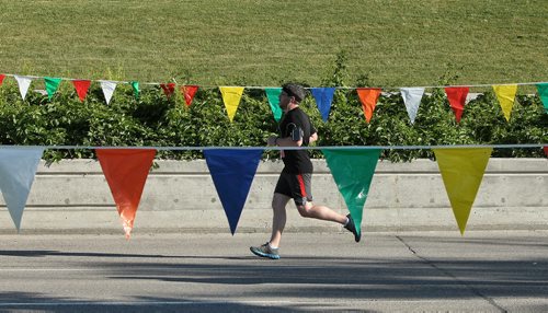 A runner takes part in the Manitoba Marathon early Sunday morning outside the IGF Stadium.  150621 June 21, 2015 MIKE DEAL / WINNIPEG FREE PRESS