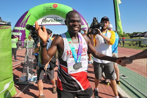 Thomas Omwenga from Kenya finishes first (2:34:17) in the men's full Manitoba Marathon Sunday morning.  150621 June 21, 2015 MIKE DEAL / WINNIPEG FREE PRESS