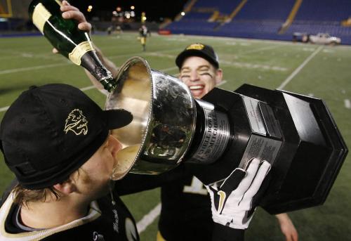 John Woods / Winnipeg Free Press / November 17/07- 071117  -  University of Manitoba Bisons Kurt Reinfort (6) drinks from the Mitchell Cup as Brad Black (1) pours the champagne as they celebrate a 52-20 win over the Western Ontario Mustangs in the Mitchell Bowl in Winnipeg Saturday Nov 17/07.