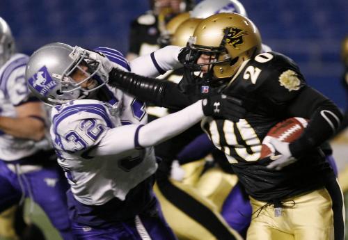 John Woods / Winnipeg Free Press / November 17/07- 071117  -  University of Manitoba Bisons Karim Lowen (20) bowls over Andrew Bain (32) in the second half of their 52-20 win over the Western Ontario Mustangs in the Mitchell Bowl in Winnipeg Saturday Nov 17/07.