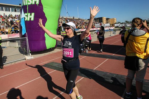 Participants in the Manitoba Marathon approach the finish line inside the University of Manitoba stadium Sunday morning. 150621 - Sunday, June 21, 2015 -  MIKE DEAL / WINNIPEG FREE PRESS